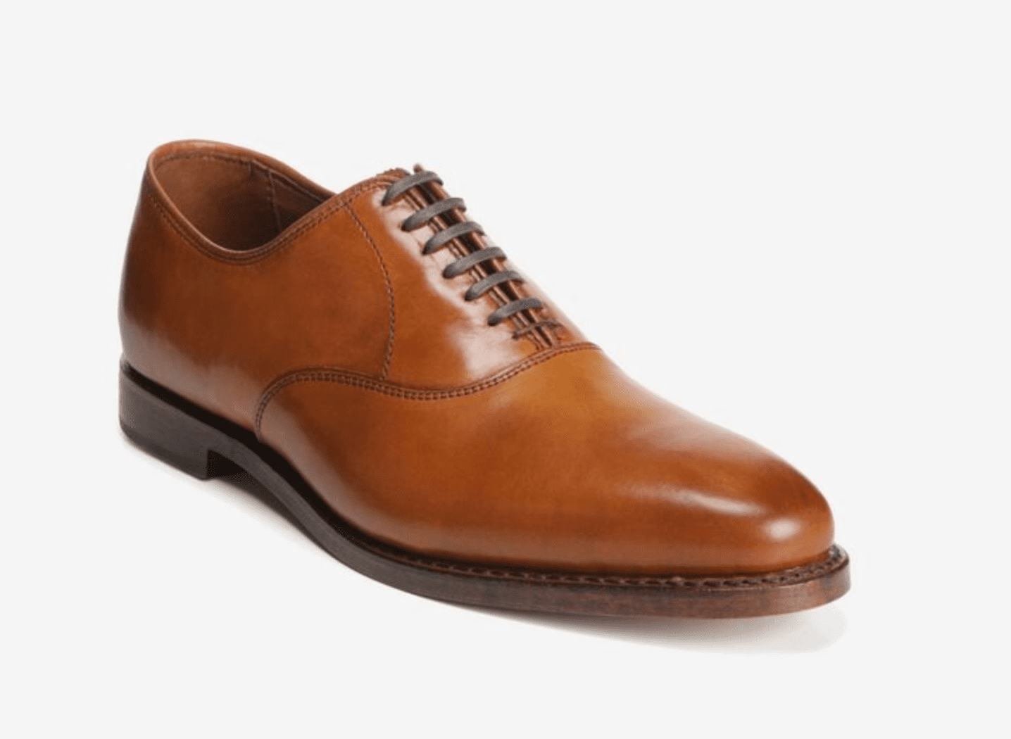 A single brown leather oxford dress shoe with closed lacing, low heel, and smooth finish, displayed on a white background.