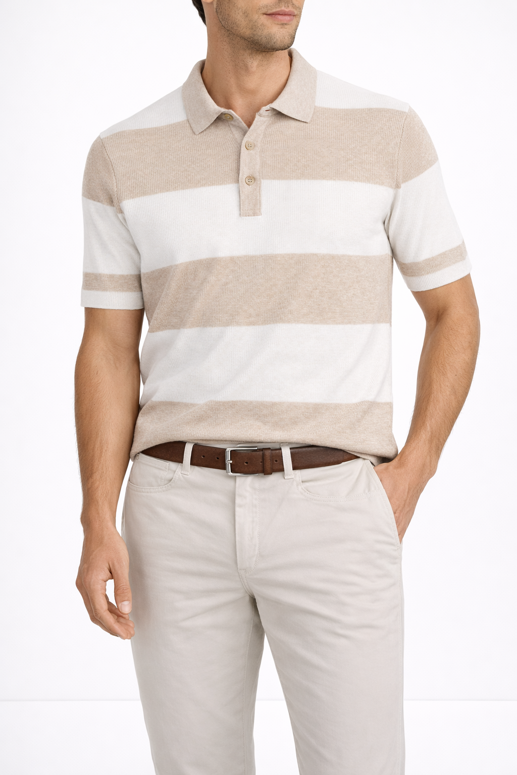 Man wearing a beige and white striped short-sleeve polo shirt, light khaki pants, and a brown belt, standing against a plain background.