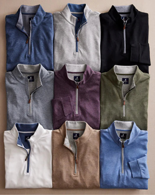 Nine folded quarter-zip pullovers in various colors, arranged in a 3x3 grid on a flat surface. Colors include blue, gray, black, purple, green, white, tan, and light blue.