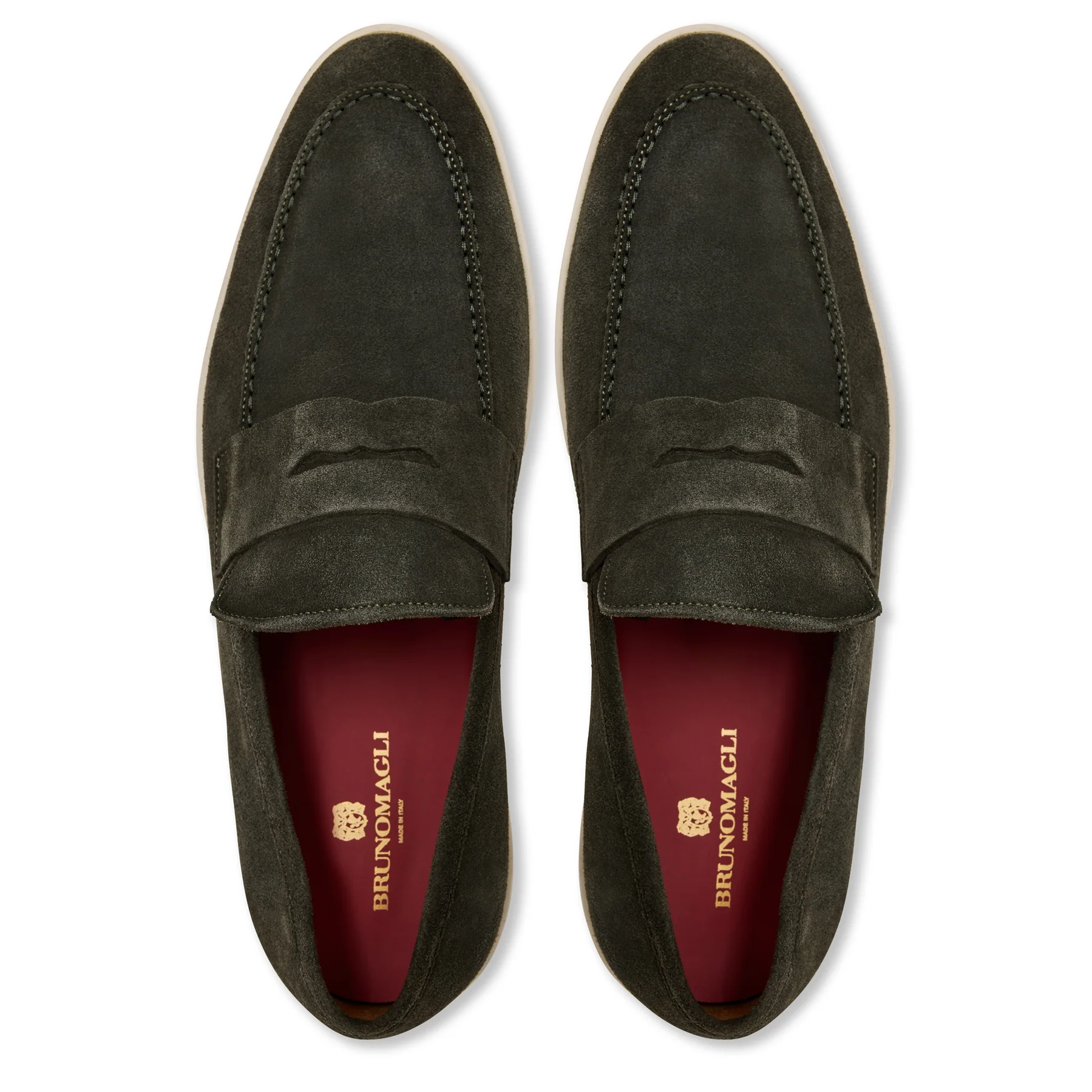 A pair of dark green suede loafers with a penny strap, featuring red insoles branded with Bruno Magli in gold text.