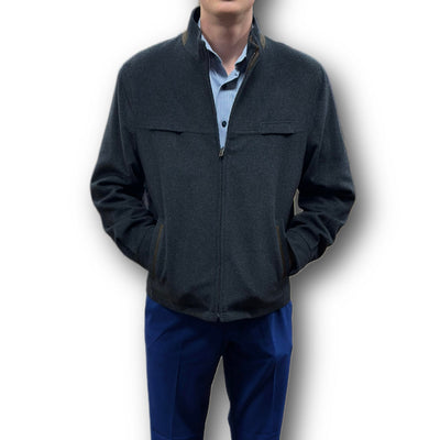 A man wearing the Enzo Coat Play by Enzo over a light blue collared shirt and blue pants stands with his hands in his jacket pockets against a white background.