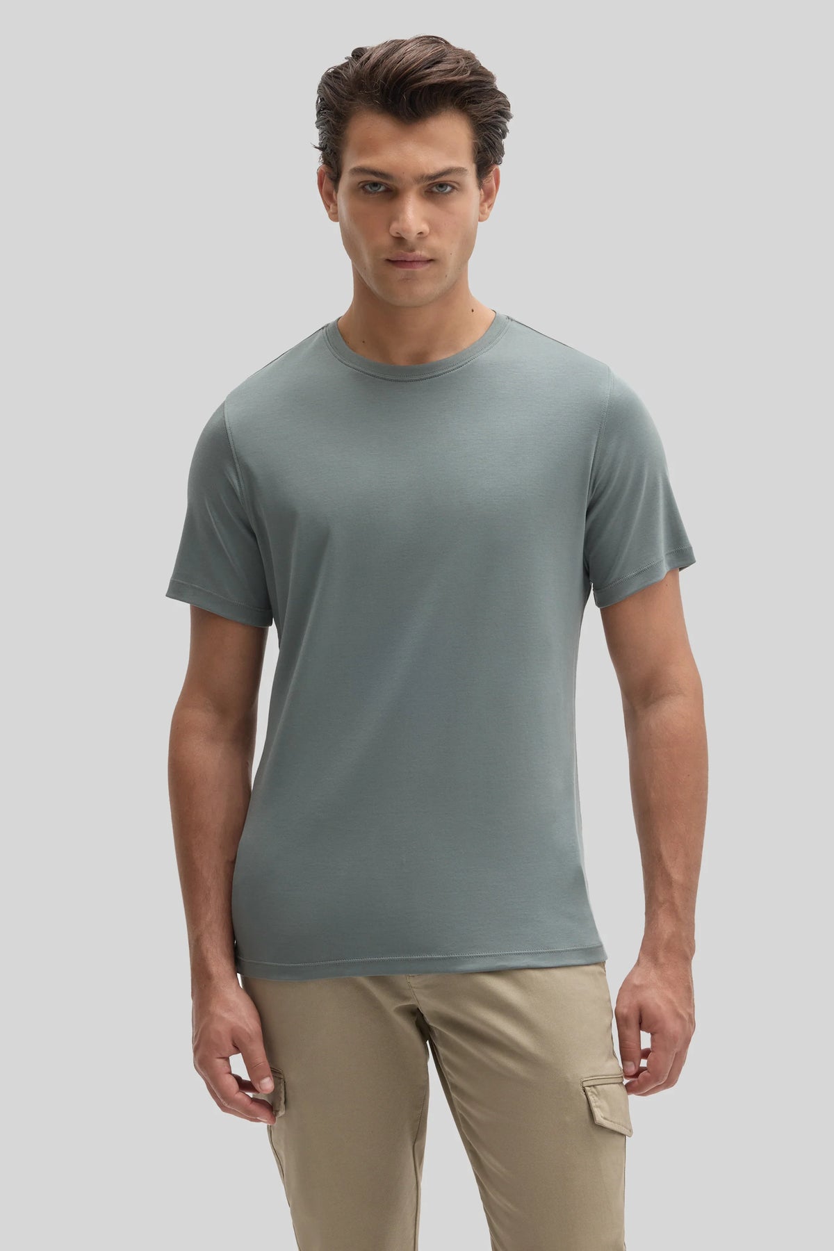 A man wearing a slate-gray Robert Barakett Tee Shirt Georgia Crew 23336 and tan cargo pants.