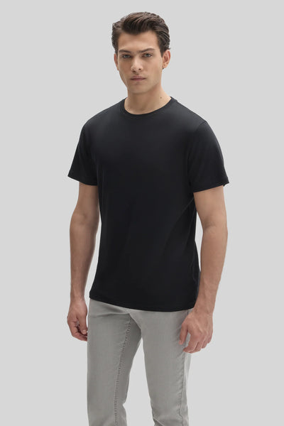 A man wearing a black Robert Barakett Tee Shirt Georgia Crew 23336 and grey pants.