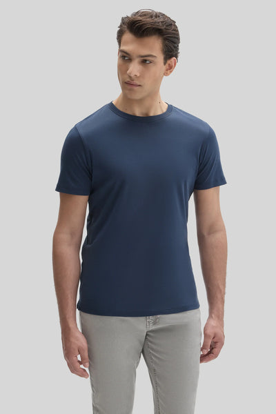 A man wearing a navy blue Robert Barakett Tee Shirt Georgia Crew 23336 and grey pants.