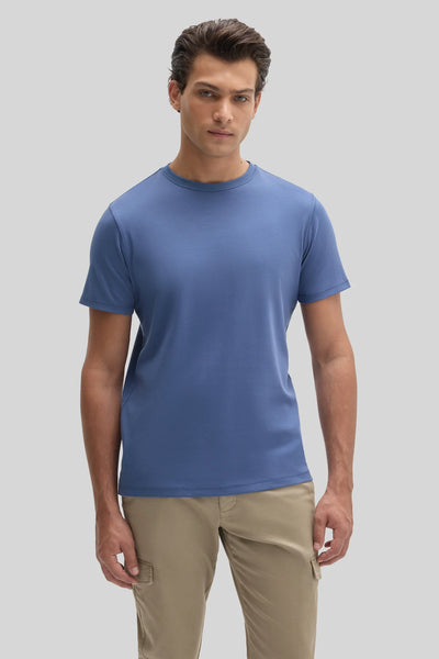 A man wearing a blue Robert Barakett Tee Shirt Georgia Crew 23336 and tan cargo pants.