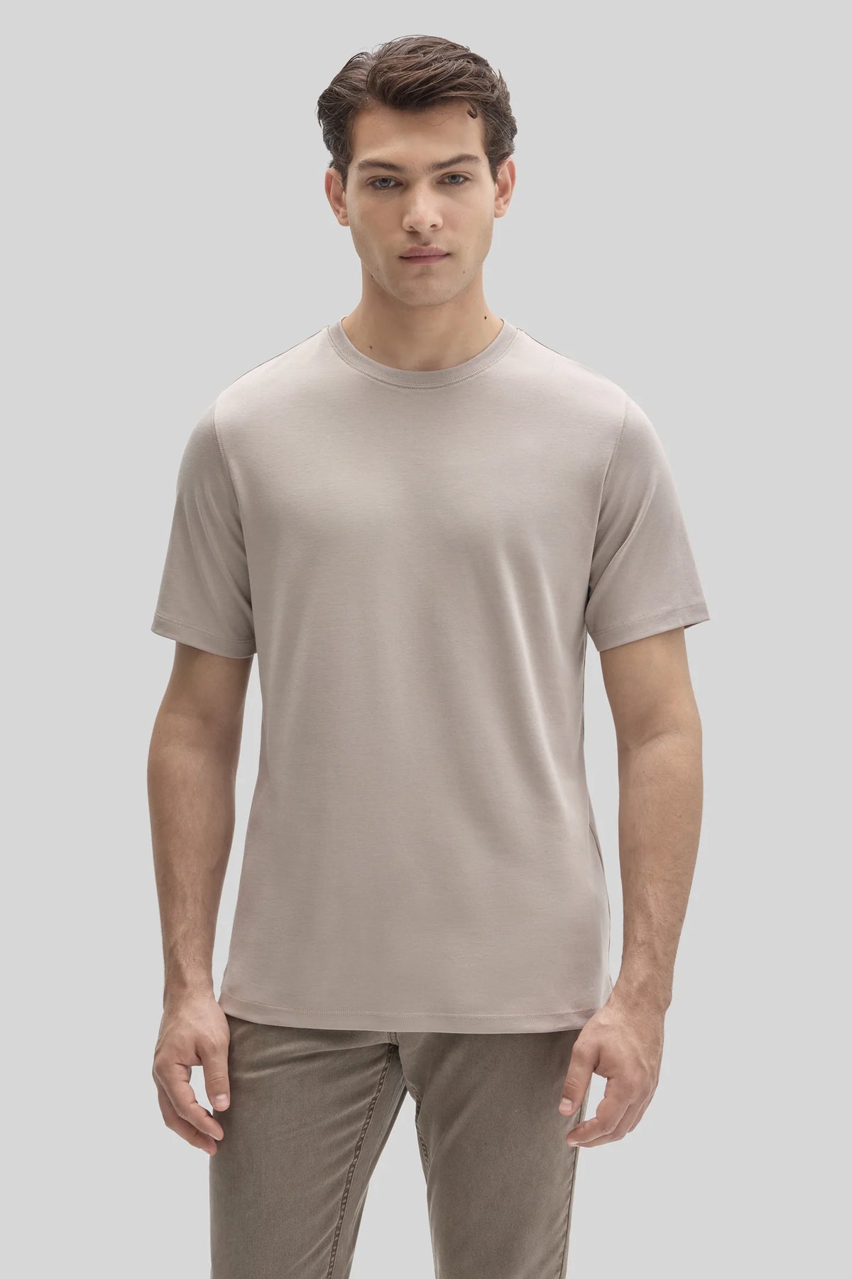 A man wearing a beige Robert Barakett Tee Shirt Georgia Crew 23336, a short-sleeved, crew-neck Pima cotton T-shirt.