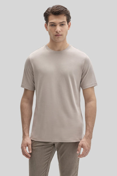 A man wearing a beige Robert Barakett Tee Shirt Georgia Crew 23336, a short-sleeved, crew-neck Pima cotton T-shirt.