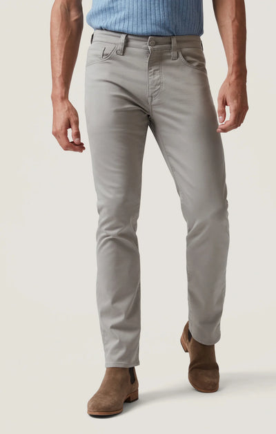 A man wearing 34 Heritage Courage Coolmax straight leg dress pants and brown suede boots.