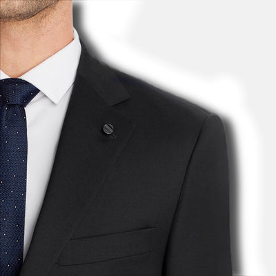 Man in a Hart Schaffner Marx Chicago Fit Suit Big & Tall, white shirt, and dark blue patterned tie, shown from the shoulders up on a light background—a refined look from Hart Schaffner Marx.