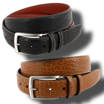 Two Torino American Bison Belts—one black, one brown—with silver buckles and visible stitching, coiled on a white background with shadows. Crafted by Torino for quality and style.