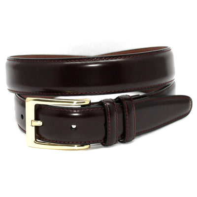 The Torino Antigua Leather Dress Belt Big & Tall by Torino features dark brown leather, visible edge stitching, and a shiny gold buckle, coiled neatly for display.