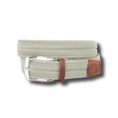 The Torino Italian Woven Herringbone Stretch Belt features a light gray herringbone pattern, silver buckle, and brown leather trim. Handcrafted in Italy, it is shown coiled against a white background.