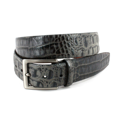The Torino Hornback Crocodile Embossed Calf Belt in black features genuine leather and a silver metal buckle, elegantly coiled in a loop against a white background.