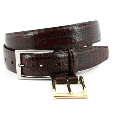The Torino Faux Alligator Grain Embossed Calfskin Belt Big & Tall by Torino, shown coiled in dark brown, features silver and gold buckles displayed side by side.