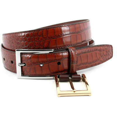 The Torino Faux Alligator Grain Embossed Calfskin Belt Big & Tall features brown calfskin with an alligator pattern, a silver rectangular buckle, and an extra gold buckle underneath. Crafted by Torino, it adds sophistication to your style.