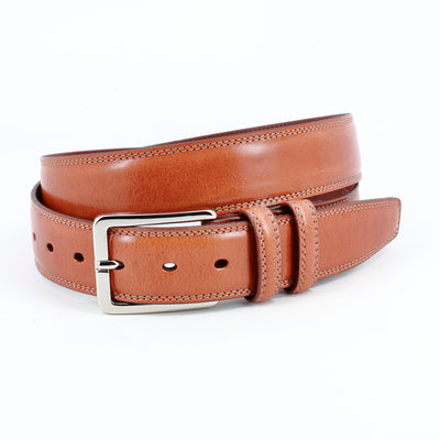A Torino Hand Antiqued Italian Calfskin Belt in tan with a silver rectangular buckle is shown rolled up against a white background.