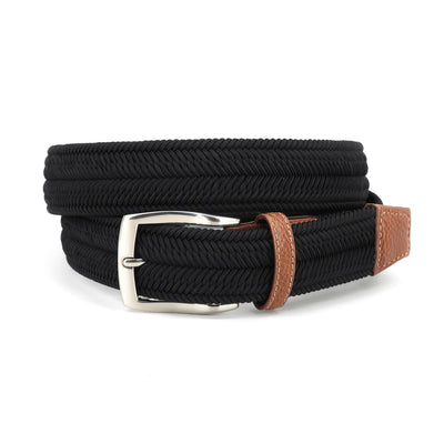 The Torino Italian Woven Herringbone Stretch Belt by Torino features a black woven design, silver buckle, and brown leather accents on the buckle and tip. Handcrafted in Italy, it is coiled on a white background.