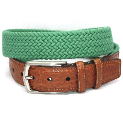 A Torino Italian Woven Cotton Elastic Belt in green rests atop a coiled saddle tan leather belt with a silver buckle, both from Torino.
