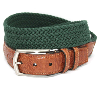 The Torino Italian Woven Cotton Elastic Belt features green woven cotton, a saddle tan leather end, and a silver buckle, shown coiled on a white background.