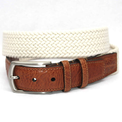 A saddle tan leather belt with a silver buckle is coiled next to a Torino Italian Woven Cotton Elastic Belt by Torino, displayed on a white background.