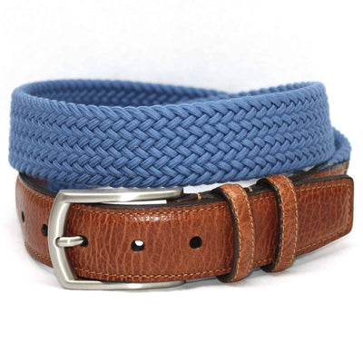 The Torino Italian Woven Cotton Elastic Belt, featuring a blue cotton weave and saddle tan leather accents, is shown coiled on a white background.