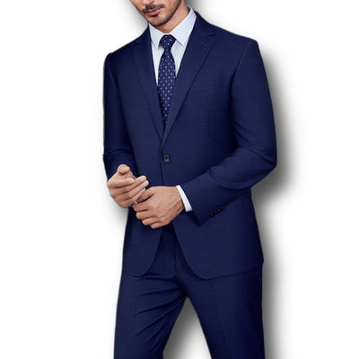 A man models the Paul Betenly Solid Suit - Slim Fit in dark blue with a white shirt and navy polka dot tie, standing against a plain white background. His head is partially out of frame.