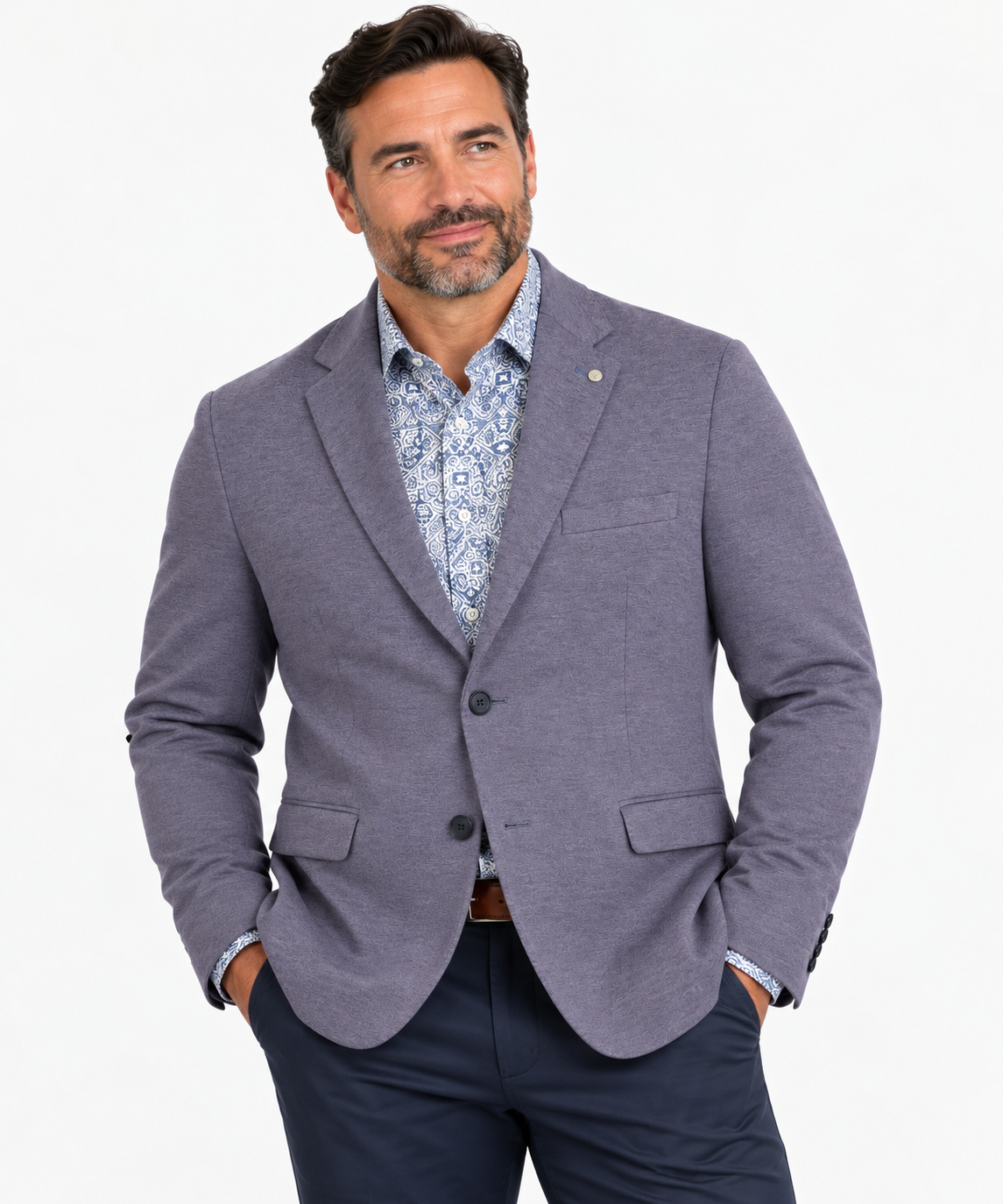Man wearing a 7 Downie St Alden Sport Coat Big & Tall, patterned dress shirt, and navy pants, standing with hands in pockets against a white background.