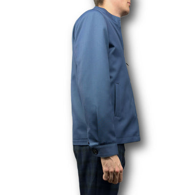 A person is shown from the side wearing the Mattarazi Coat Paolo by Mattarazi in blue with plaid pants, set against a white background.