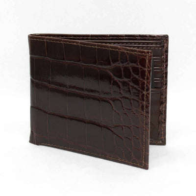 The Torino Genuine Alligator Billfold Wallet, in dark brown with a crocodile pattern, is partially open and shown against a plain white background.