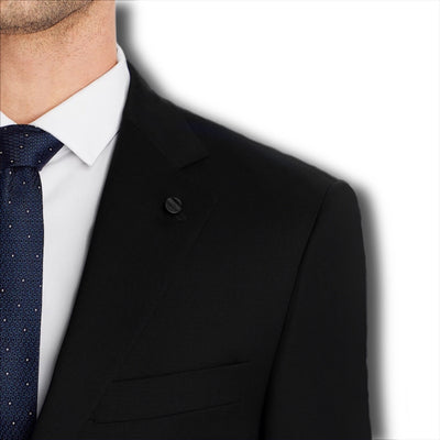 Man wearing a Hart Schaffner Marx Chicago Fit Suit Big & Tall jacket, white dress shirt, and blue patterned tie; only his left upper body and face are visible against a plain white background, highlighting luxury men's workwear.