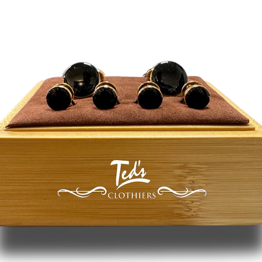 The Bocara Stud & Cufflinks Set by Bocara, a classic formal accessory in black onyx, is displayed in a brown velvet box featuring the Teds Clothiers logo.