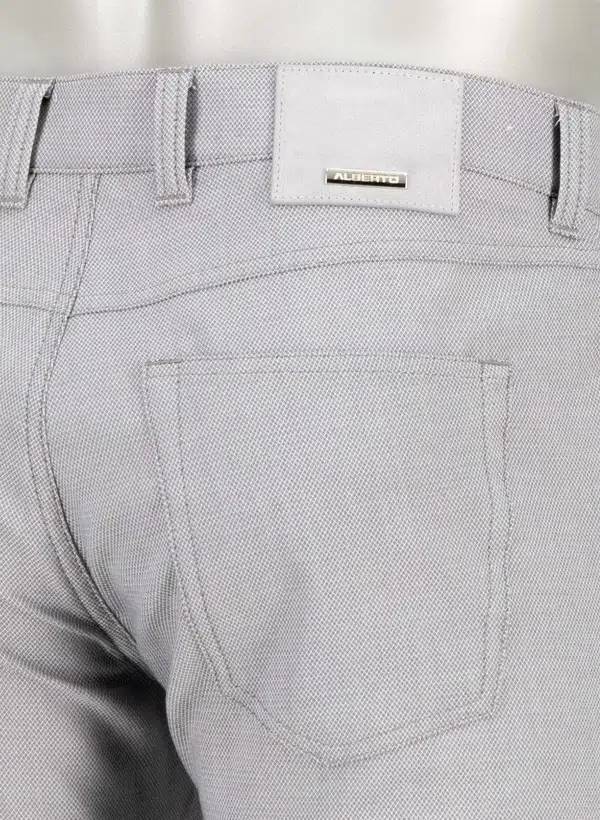 Close-up of gray pants with alberto  brand label on a white background