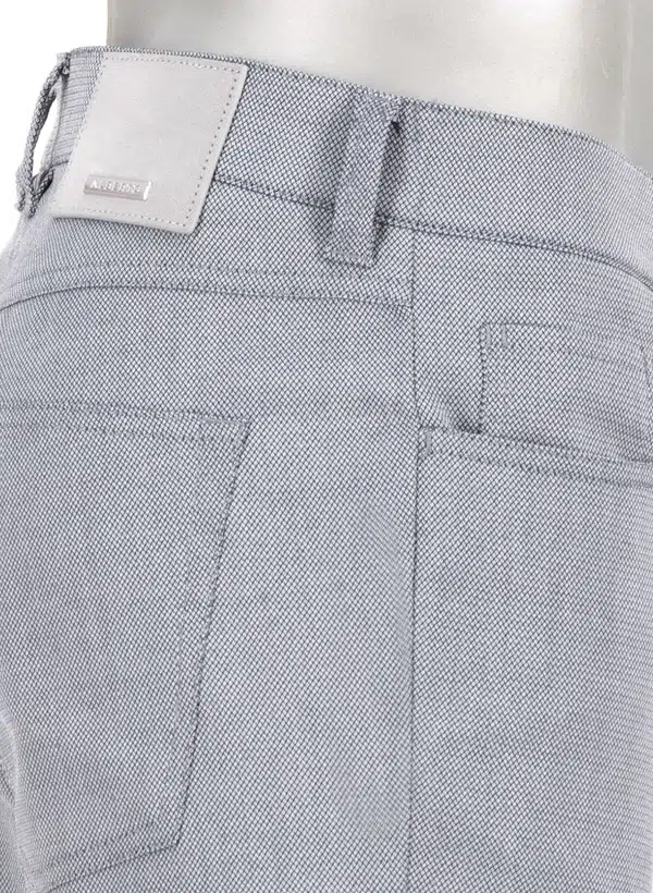 Close-up of light blue pants with alberto brand label on a white background