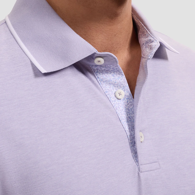 Close-up of a light purple polo shirt with a collar and buttons.