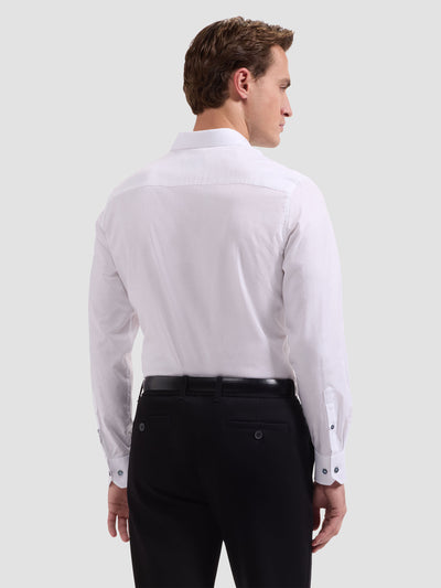 Man wearing a white dress shirt and black pants on a light gray background