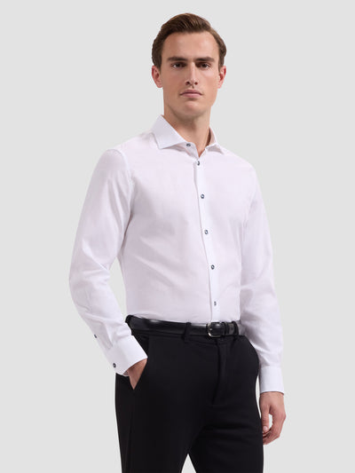 Man wearing a white dress shirt and black pants on a light gray background