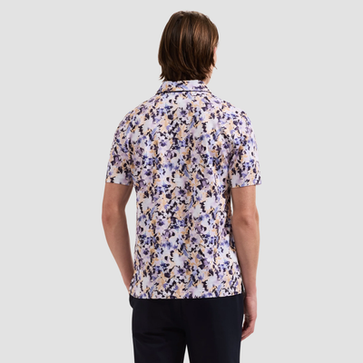 Person wearing a floral short-sleeve shirt on a light gray background
