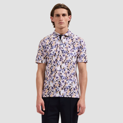 Man wearing a patterned shirt against a plain background