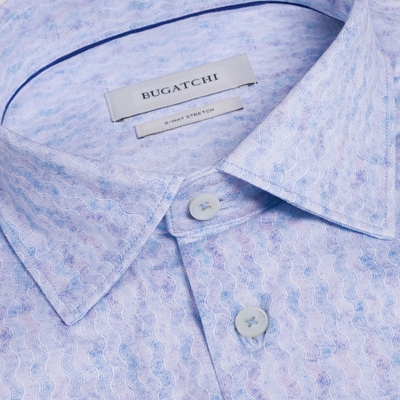 Close-up of a light blue patterned shirt with 'Bugatchi' label.