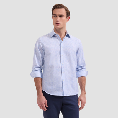 Man wearing a light blue checkered shirt and dark pants on a white background
