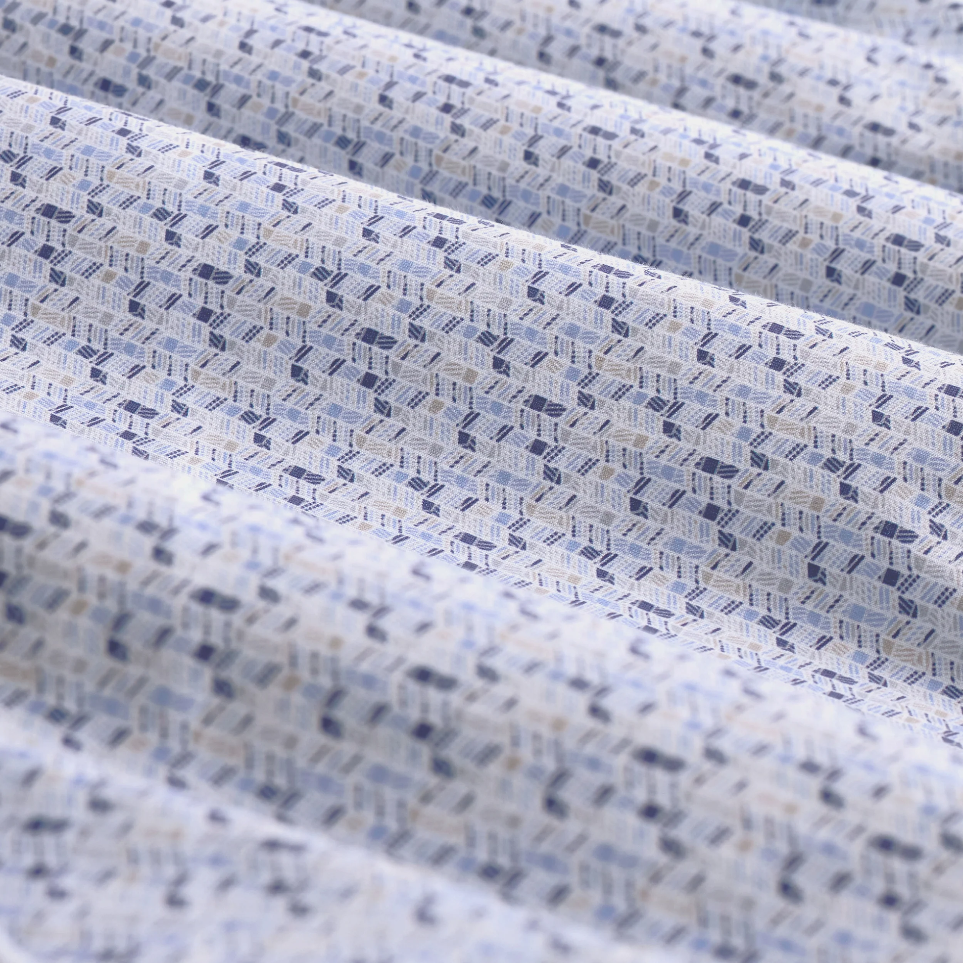 Close-up of textured fabric with a subtle pattern in shades of blue and gray.