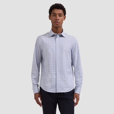 Man wearing a light blue patterned shirt on a gray background