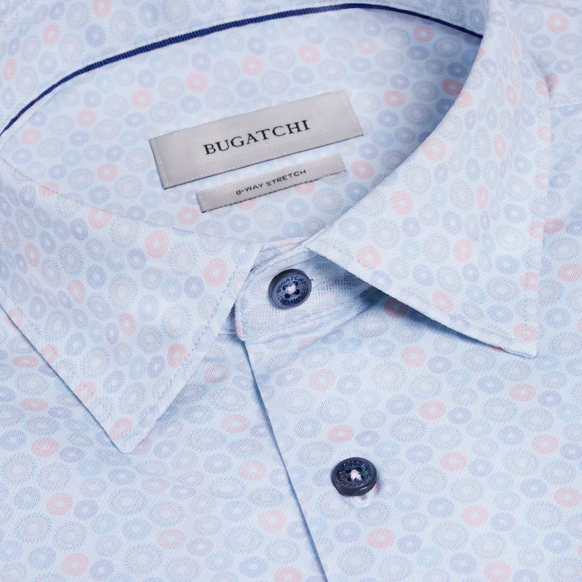Close-up of a Bugatchi shirt with a patterned design and brand label.