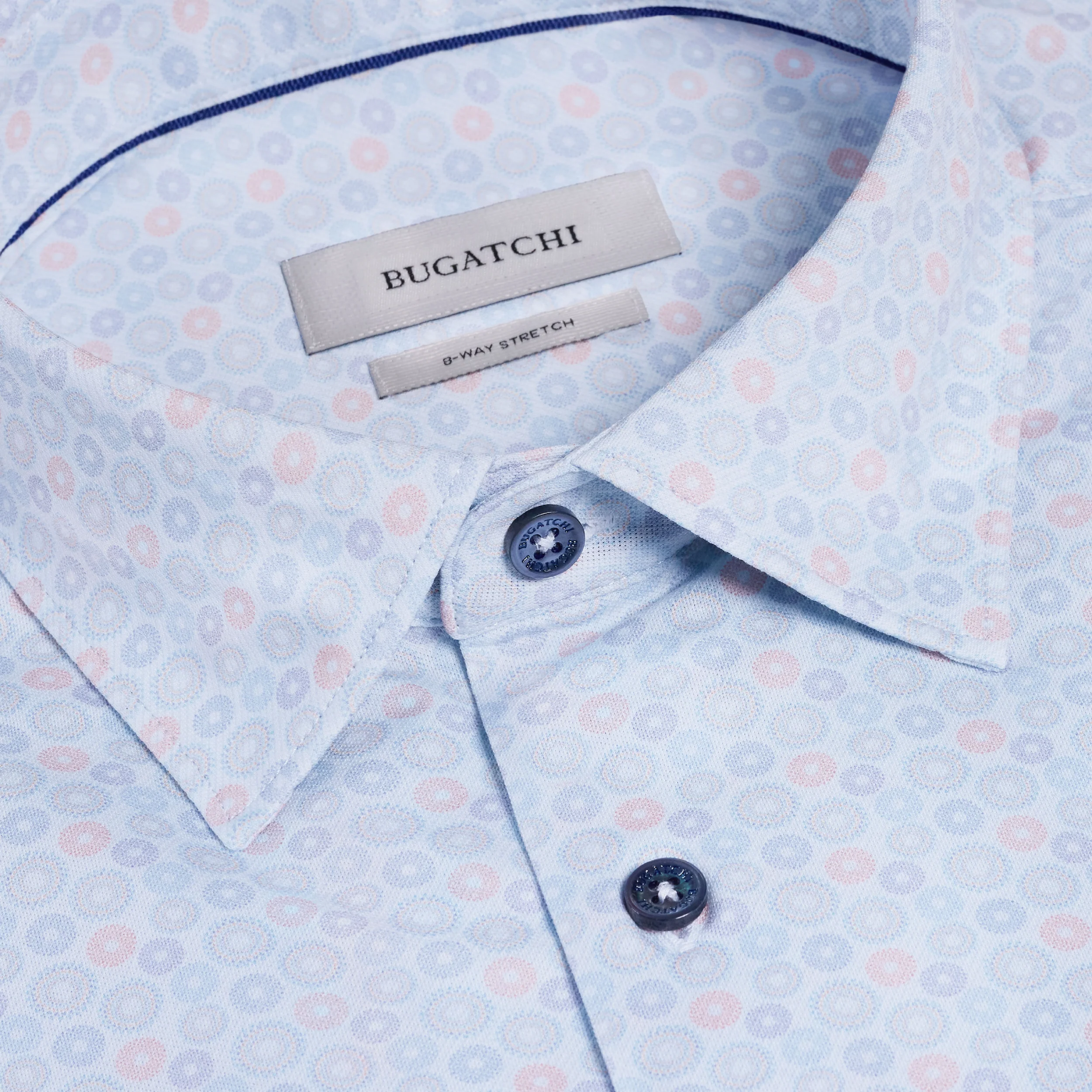 Close-up of a Bugatchi shirt with a patterned design and brand label.