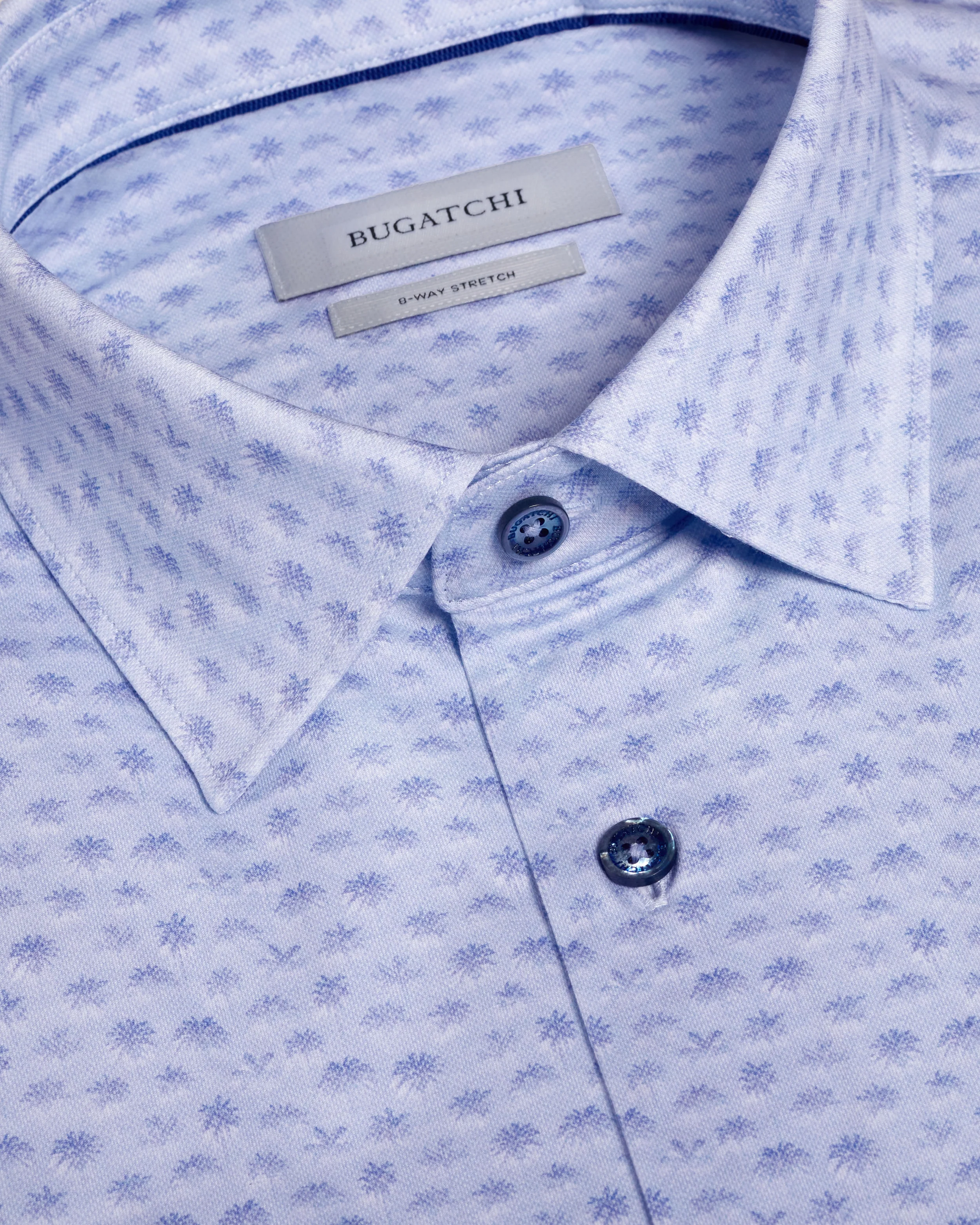 Close-up of a light blue patterned shirt with Bugatchi branding.