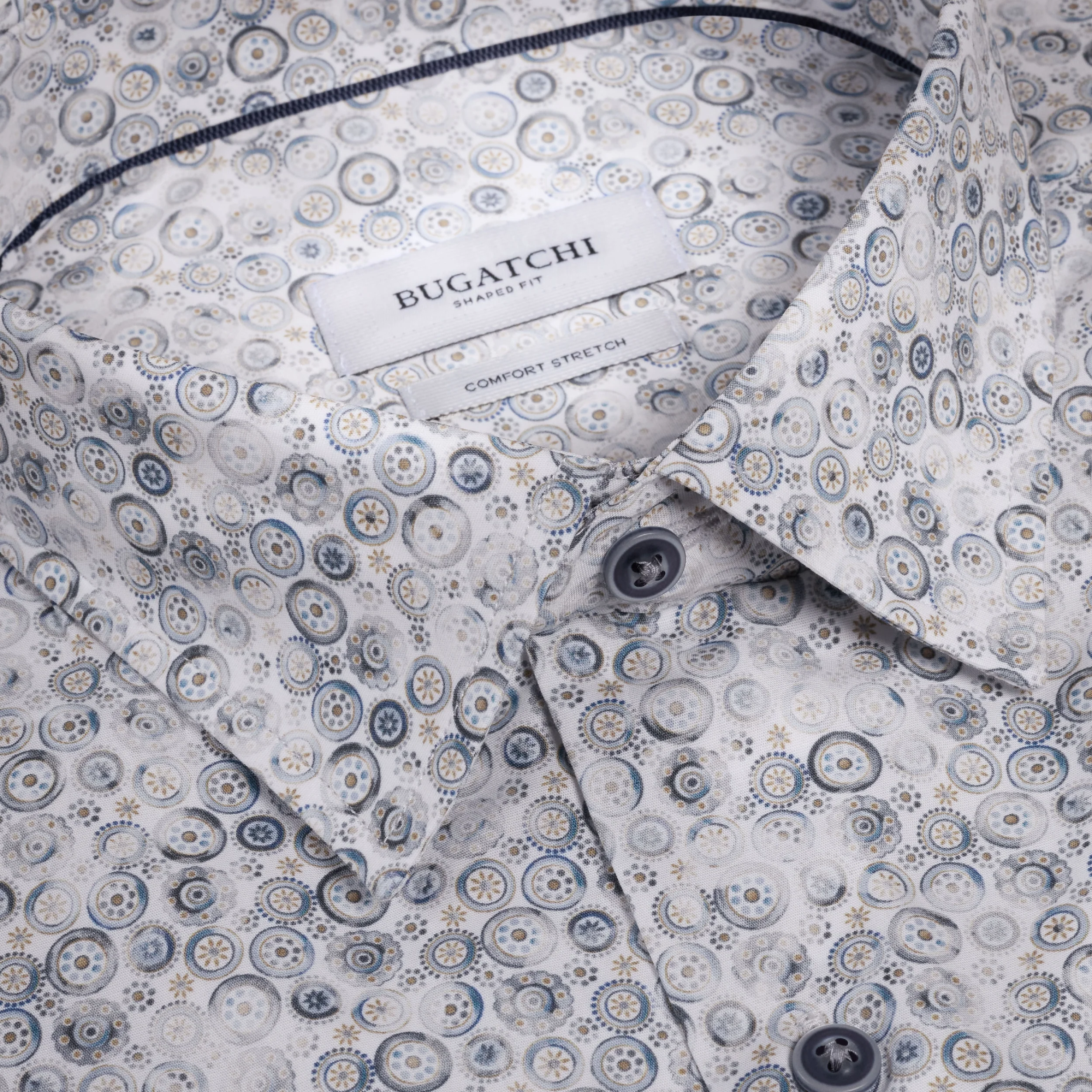 Folded Bugatchi shirt with circular pattern on a white background