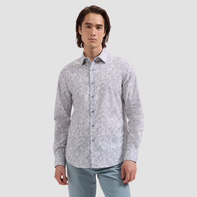 Man wearing a light gray patterned shirt on a white background