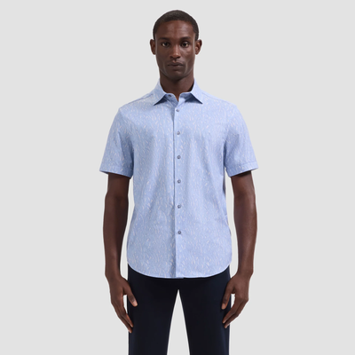 Man wearing a light blue short-sleeve shirt on a plain background