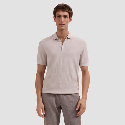 Man wearing a light gray polo shirt and pants on a white background
