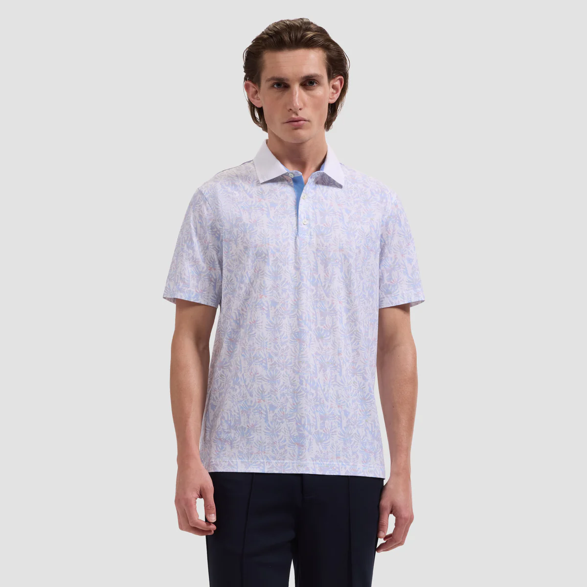 Man wearing a light blue patterned shirt on a white background